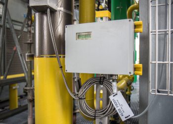 Geschützt durch ein Rose-Aluminiumgehäuse misst ein Clamp-On-Ultraschallsystem von Flexim eingriffsfrei den Durchfluss von warmem Ammoniakgas in der Kältezentrale eines Chemieparks. (Bild: Flexim)